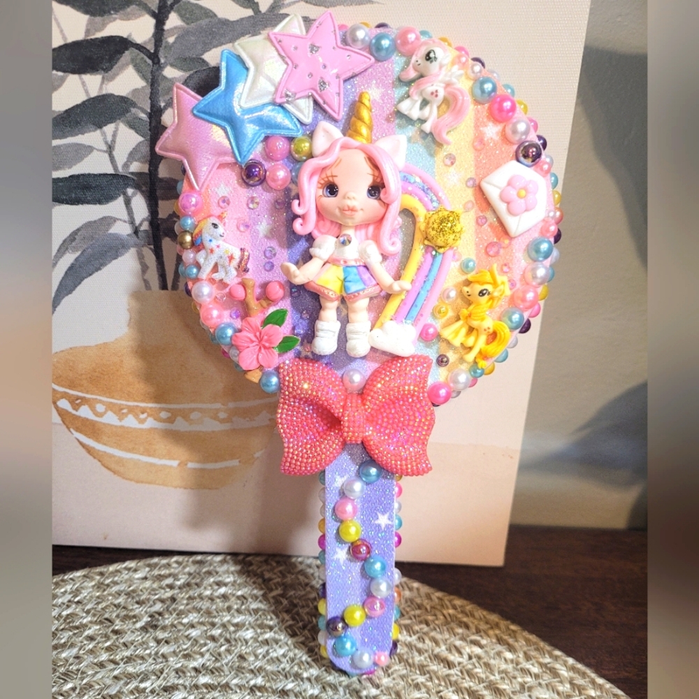 Beautiful handmade unicorn mirror with pink and purple details.